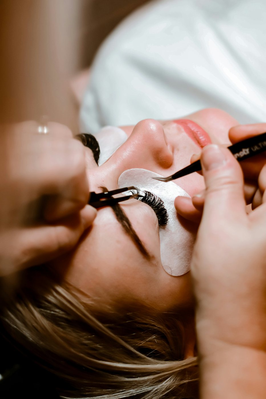 Lash extensions being applied